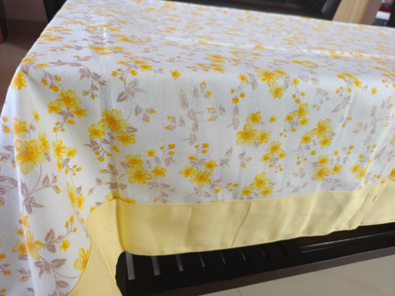 Tablecloth with yellow floral pattern on a table