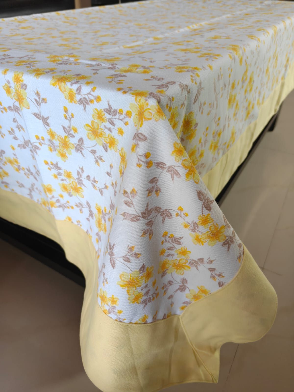 Floral tablecloth with yellow flowers on a plain background