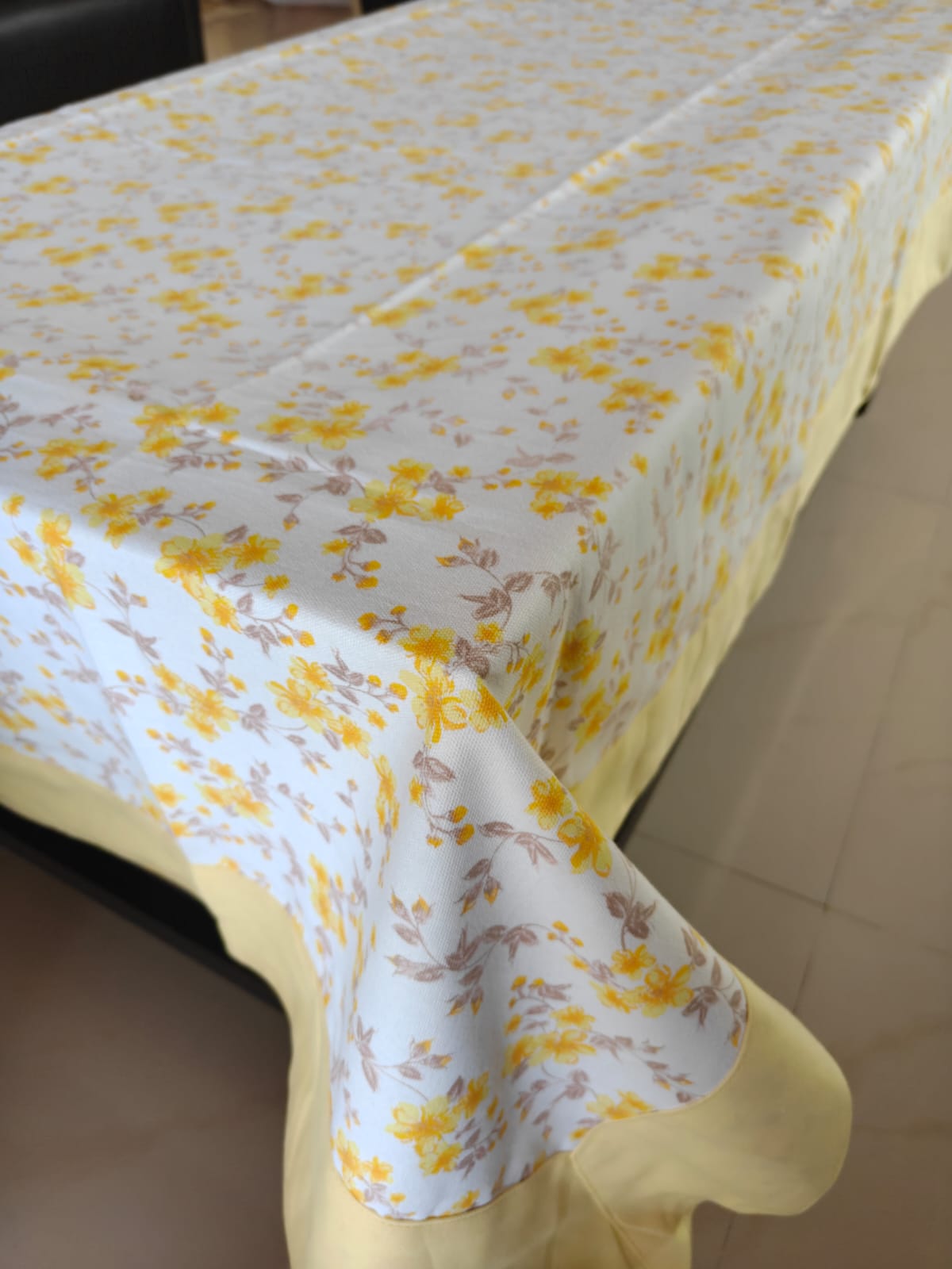 Tablecloth with yellow floral pattern on a table
