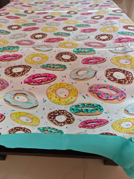 Tablecloth with colorful donut pattern on a table