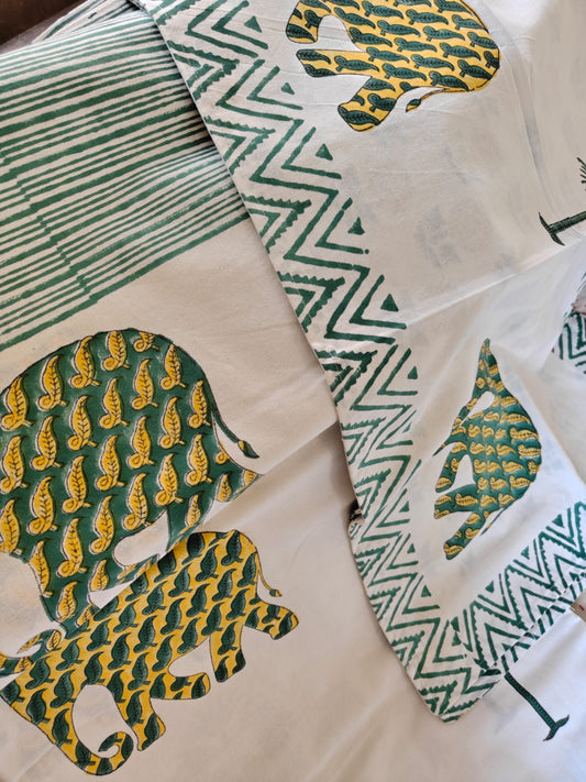 Hand block with green and yellow patterns on a white background