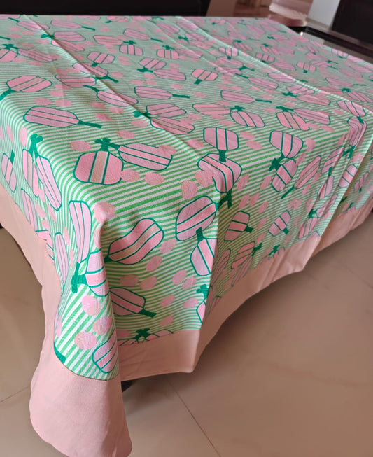 Tablecloth with pink and green pattern on a table