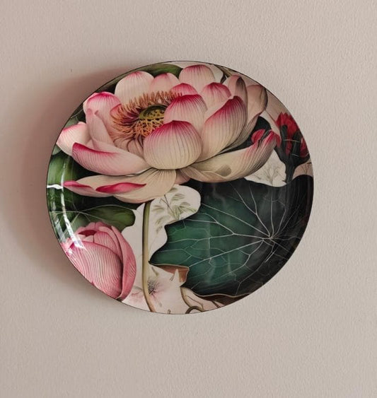 Decorative plate with a pink lotus flower design on a beige background