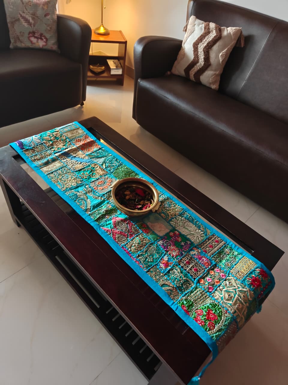 Decorative table runner on a coffee table in a living room setting
