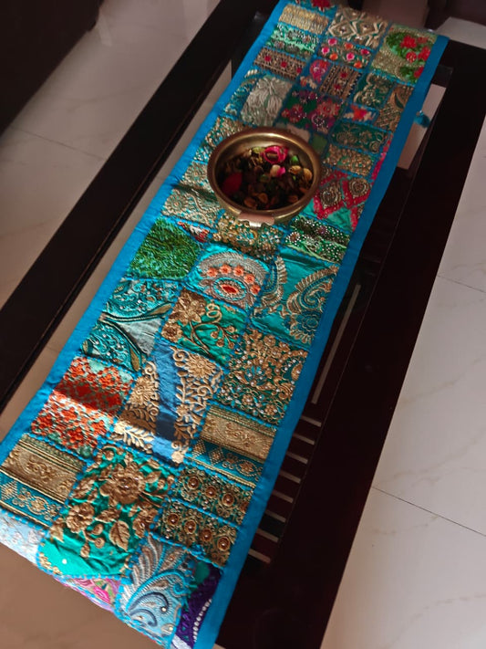 Decorative table runner with intricate patterns on a dark surface