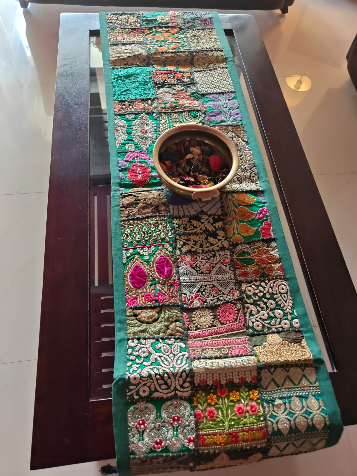 Decorative embroidered table runner on a wooden table