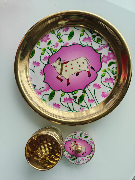 Brass plate with a cow illustration on a white background