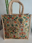 Decorative jute bag with colorful pattern on a light background