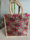 Tote bag with elephant pattern and jute handles on a neutral background