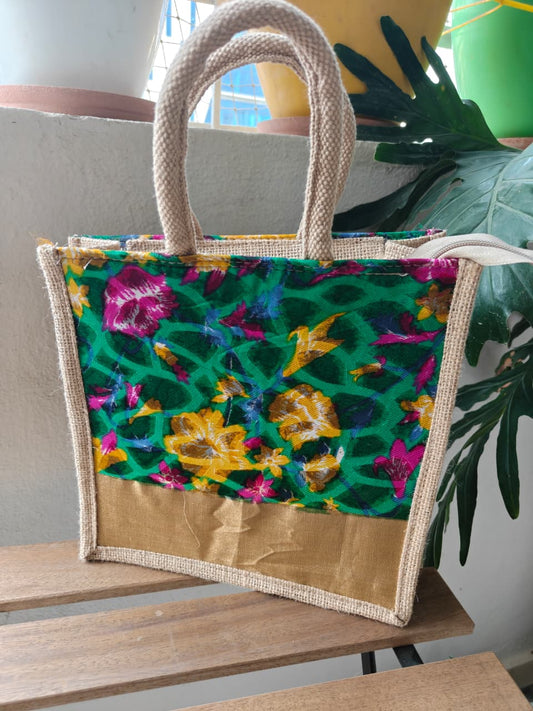 Colorful floral-patterned bag with jute handle on a wooden surface