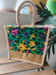 Colorful floral-patterned bag with jute handle on a wooden surface