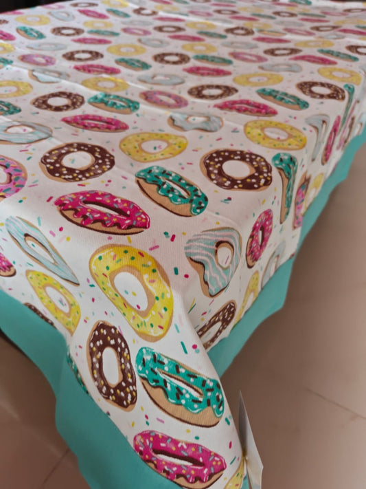 Tablecloth with colorful donut pattern on a table
