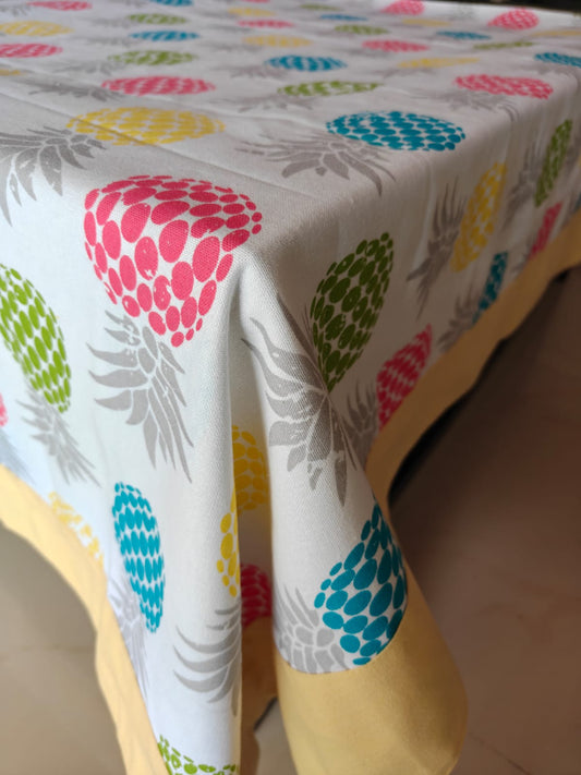 Colorful tablecloth with pineapple pattern on a table